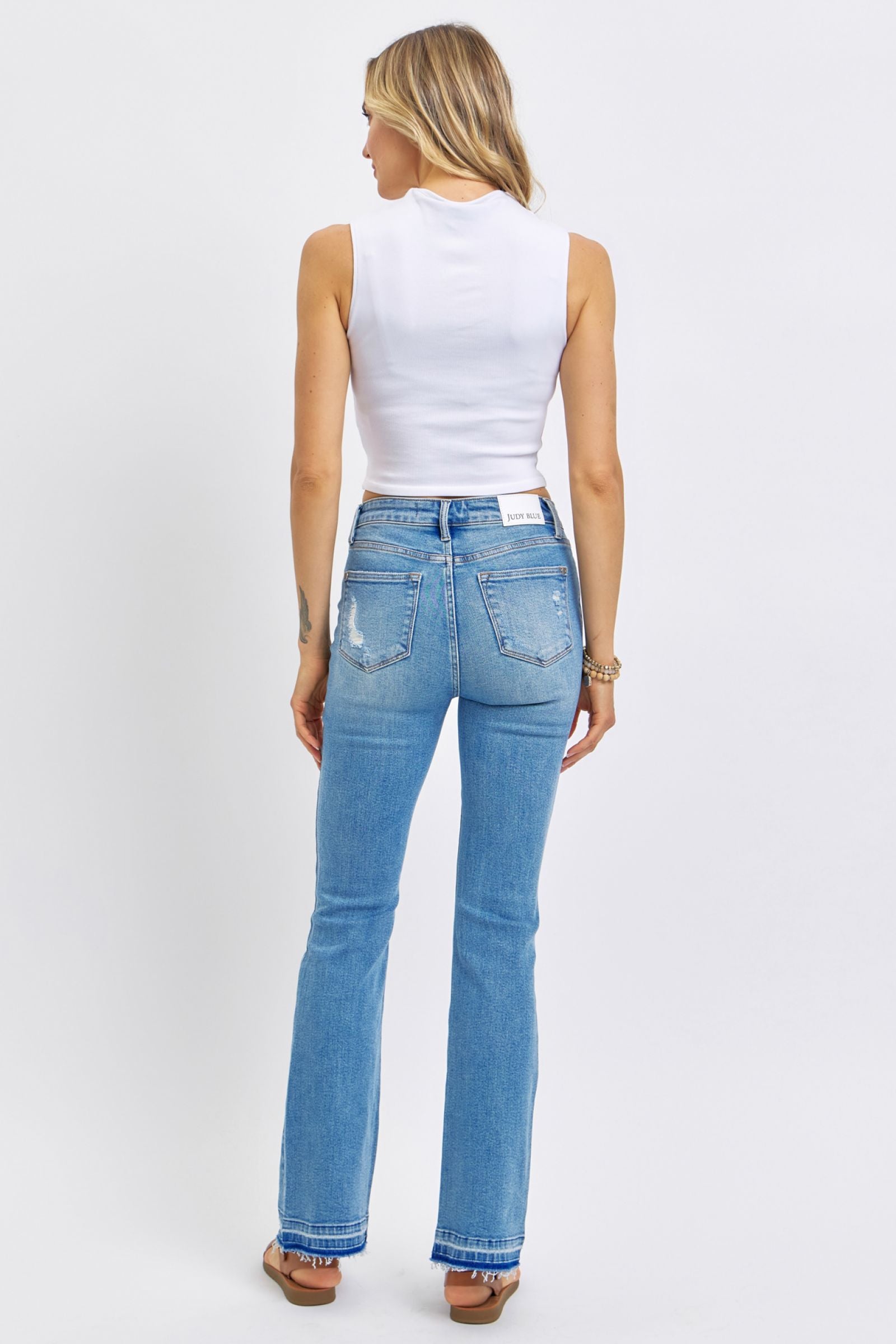 MEDIUM WASH MID RISE DESTROYED RELEASED HEM BOOTCUT JUDY BLUE DENIM