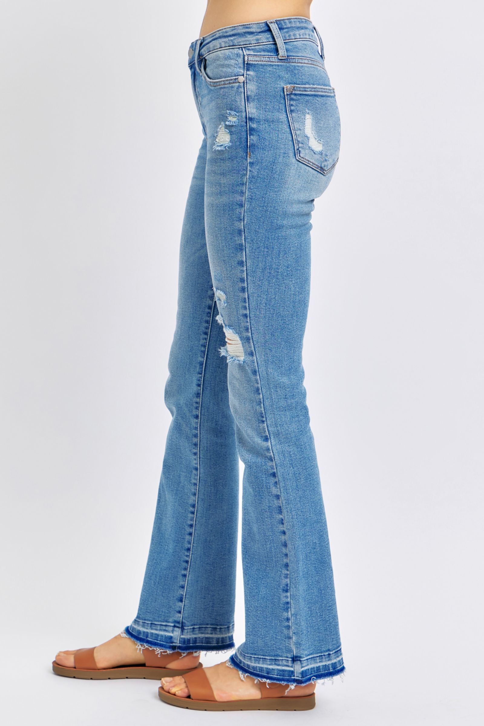 MEDIUM WASH MID RISE DESTROYED RELEASED HEM BOOTCUT JUDY BLUE DENIM