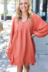 RUST WAFFLE KNIT WOVEN VNECK BABYDOLL DRESS