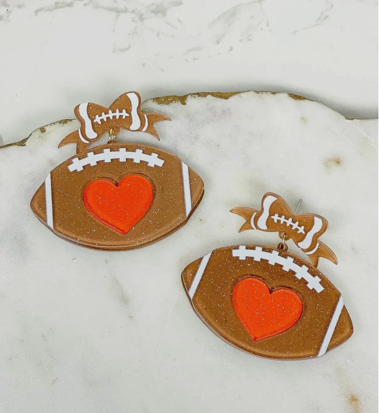 ACRYLIC GLITTER FOOTBALL ORANGE HEART FOOTBALL BOW TWO TIER EARRINGS BY P.O.