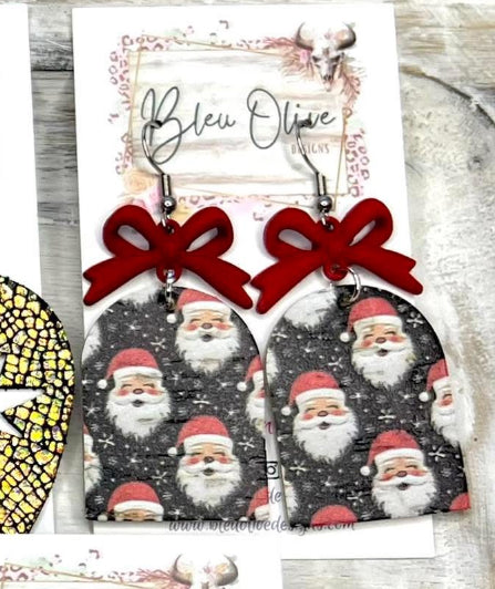 SANTA CLAUS PRINTED LEATHER WITH RED METAL BOWS ON BLACK BACKGROUND HANDMADE EARRINGS BY B.O.D