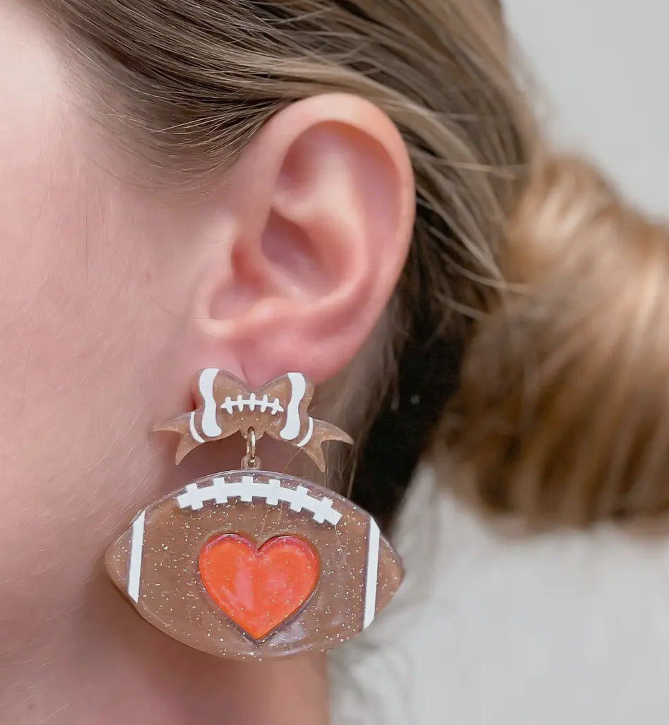 ACRYLIC GLITTER FOOTBALL ORANGE HEART FOOTBALL BOW TWO TIER EARRINGS BY P.O.